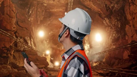 Asian Male Engineer Taking Note On The Tablet In Mine tunnel Stock Footage 299571792