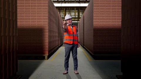 Asian Male Engineer Thinking About Something With Brick In Stacks Stock Footage 303761148