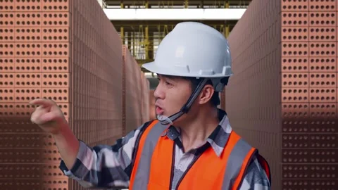 Asian Male Engineer Using Smartphone With Brick In Stacks Stock Footage 303760945