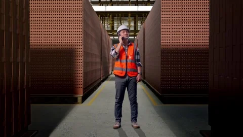 Asian Male Engineer Using Smartphone With Brick In Stacks Stock Footage 303761225