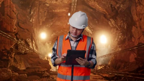 Asian Male Engineer Working On A Tablet In Mine tunnel Stock Footage 299568379