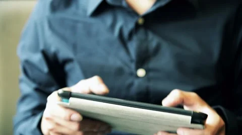 Asian male enjoy using tablet to play game Stock Footage 63397989