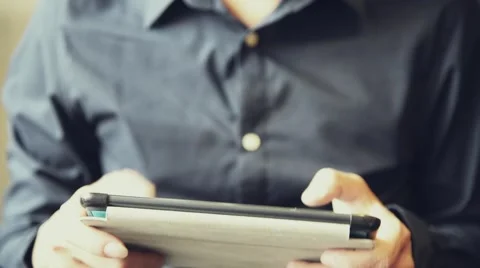 Asian male enjoy using tablet to play game Stock Footage 63398363