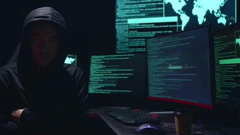 Asian Male Hacker Pose With Code On Multiple Computer Screens And Downloading Stock-Footage 157497403