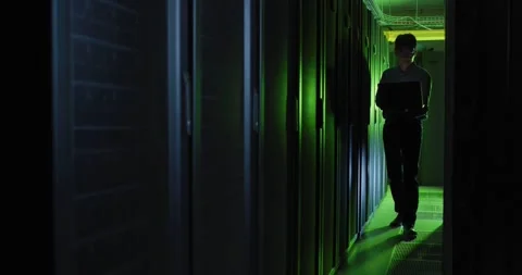 Asian male it technician using laptop checking computer server Stock Footage 344252225