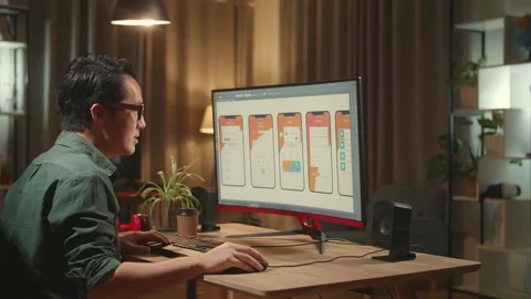 Asian Male Mobile Application Developer Stretching While Works With Graphics Stock Footage 157779362