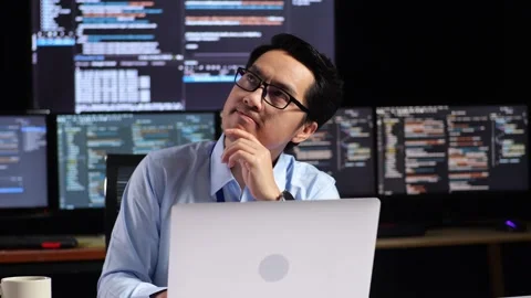 Asian Male Programmer Thinking About Something And Raising His Index Finger Stock Footage 230180031