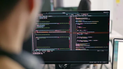 Asian Male Programmer Writing Code on Dual Monitors in Modern Office. Stock-Footage 300246332
