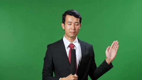 Asian Male Tv News Reporter In Formal Wear Talking On A Green Screen, Chroma Key Stock Footage