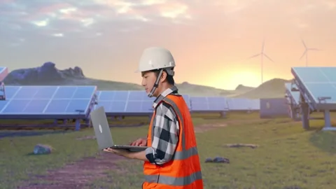 Asian Male Use Computer While Walking on Energy Farm Stock Footage 331017041