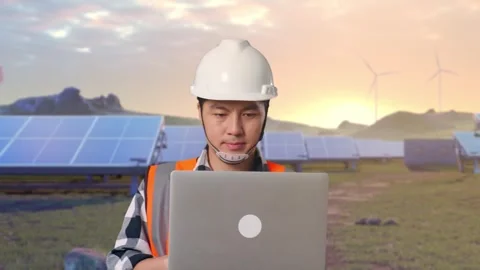 Asian Male Use Computer While Walking on Energy Farm Stock Footage 331017533