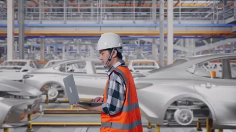 Asian Male Use Computer While Walking In Car Factory Stock Footage 331580952