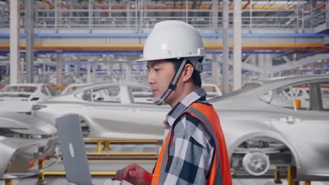 Asian Male Use Computer While Walking In Car Factory Stock Footage 331581065