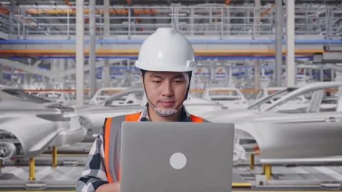 Asian Male Use Computer While Walking In Car Factory Stock Footage 331581269