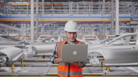 Asian Male Use Computer While Walking In Car Factory Stock Footage 331581440