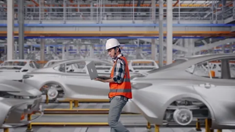 Asian Male Use Computer While Walking In Car Factory Stock Footage 331581685