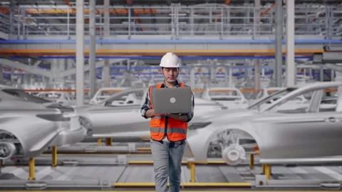 Asian Male Use Computer While Walking In Car Factory Stock Footage 331581864