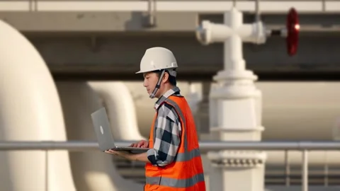 Asian Male Use Computer While Walking at Energy Plant Stock Footage 331635798