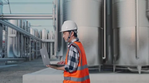 Asian Male Use Computer While Walking at Chemical Plant Stock Footage 332548075