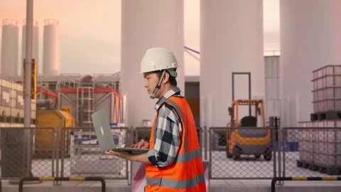 Asian Male Use Computer While Walking at Storage Facility Stock Footage 335072026