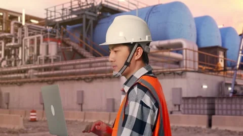 Asian Male Use Computer While Walking at Gas Plant Stock Footage 337756787