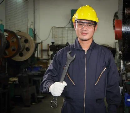 Asian male worker In industries that wear glasses, safety hats and safety uni Stock Photos