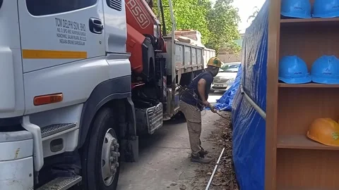 Asian Male Worker Loading Rusty Iron by Hand into Truck. Stock Footage 309306972