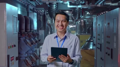 Asian Male Worker Smiling At The Camera In Engine Control Room Stock Footage 292372410