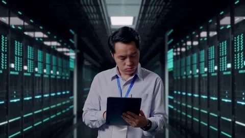 Asian Male Worker Use Tablet And Headache in Data Center Stock Footage 321990588