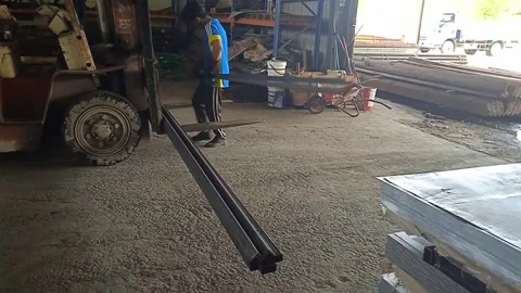Asian Male Worker Working Inside Warehouse Moving Steel by Hand to Forklift Stock Footage 309306804