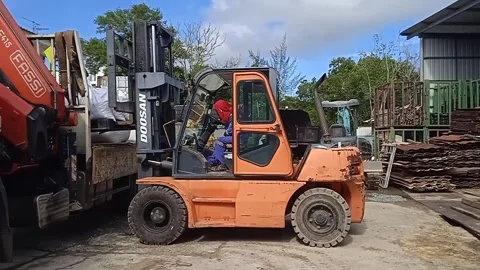 Asian male workers loading building materials with forklift Stock Footage 304610403