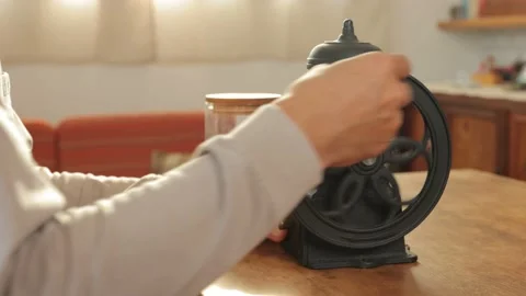 Asian male's hand spinning mill to grind coffee beans at home. No face. 25P. Stock Footage 224901448
