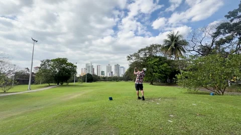 Asian Man in Aloha Shirt Practicing Golf Swing on Manila Fairway Video stock 334161715