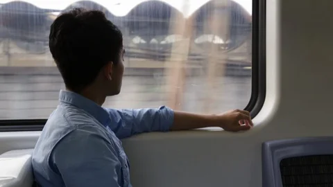 Asian man, alone in a train, looking out the window Video stock 88440827