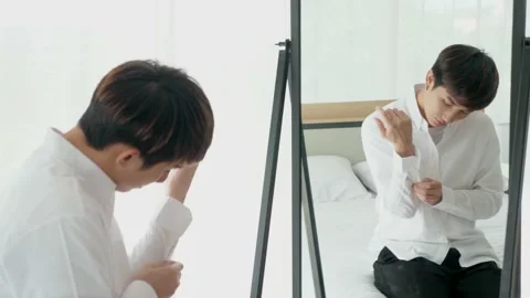 Asian man and the reflection in the mirror, dress up, put on cuff button Stock Footage 144436925