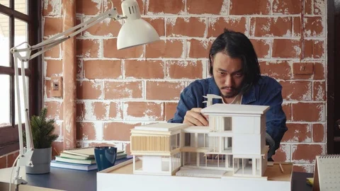 Asian man architecture/designer selecting wall color for model house/home pro Stock Footage 111679470