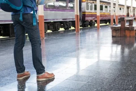Asian man with backpack standing on platform at train station. backpacker or  写真素材