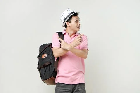 Asian man backpacker with confused expression. travelling concept. on isola.. Stock Photos