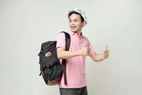 Asian man backpacker give thumb up gesture. digital nomad and travelling co.. Stock Photos