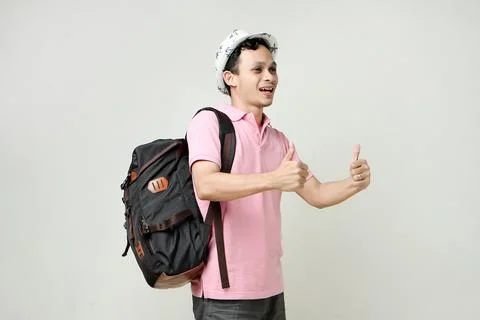 Asian man backpacker give thumb up gesture. digital nomad and travelling co.. Stock Photos