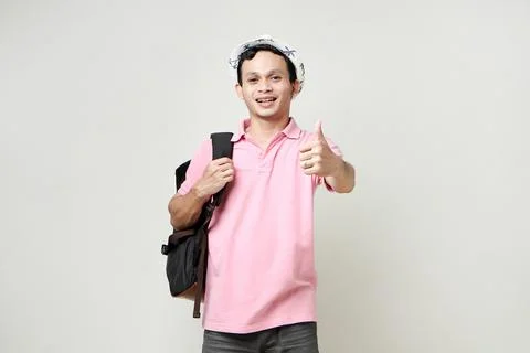 Asian man backpacker give thumb up gesture. digital nomad and travelling co.. Stock Photos