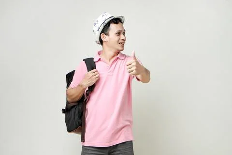 Asian man backpacker give thumb up gesture. digital nomad and travelling co.. Stock Photos
