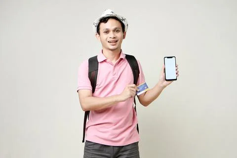 Asian man backpacker holding mobile phone and credit card. digital nomad an.. Stock Photos