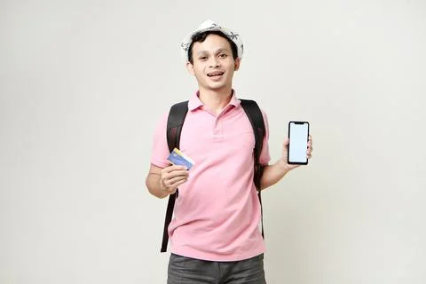 Asian man backpacker holding mobile phone and credit card. digital nomad an.. Stock Photos