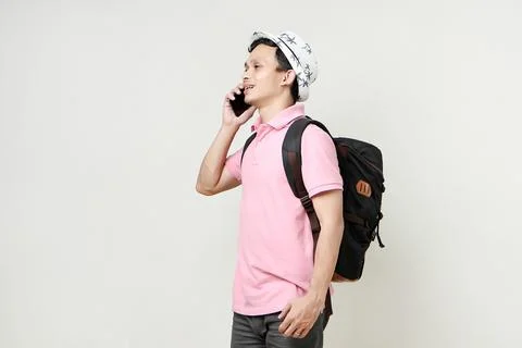 Asian man backpacker making a phone call. digital nomad and travelling conc.. Stock Photos