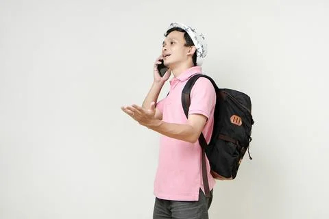 Asian man backpacker making a phone call. digital nomad and travelling conc.. Stock Photos