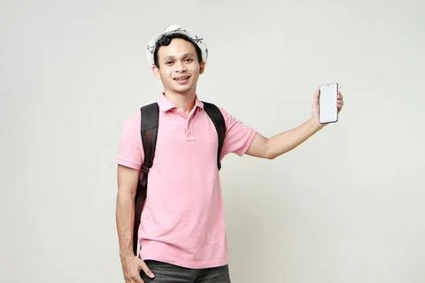 Asian man backpacker showing cellphone blank screen with empty space for mo.. Stock Photos