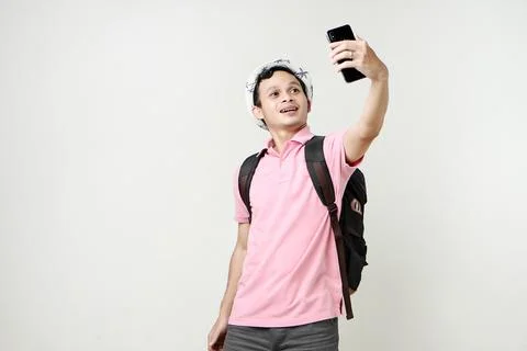 Asian man backpacker taking selfie photos with mobile phone. digital nomad .. Stock Photos