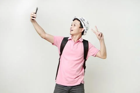 Asian man backpacker taking selfie photos with mobile phone. digital nomad .. Stock Photos