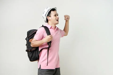 Asian man backpackershowing strength gesture with arms. digital nomad and t.. Stock Photos